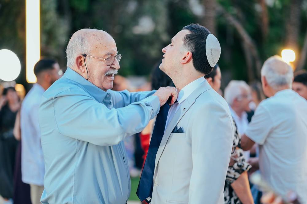 סבא מיישר את עניבת החתן